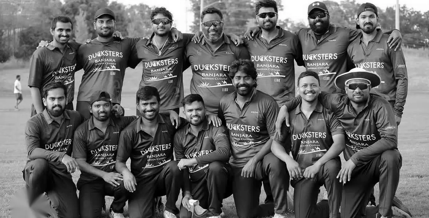 Cricket team in matching custom jerseys posing together after a match